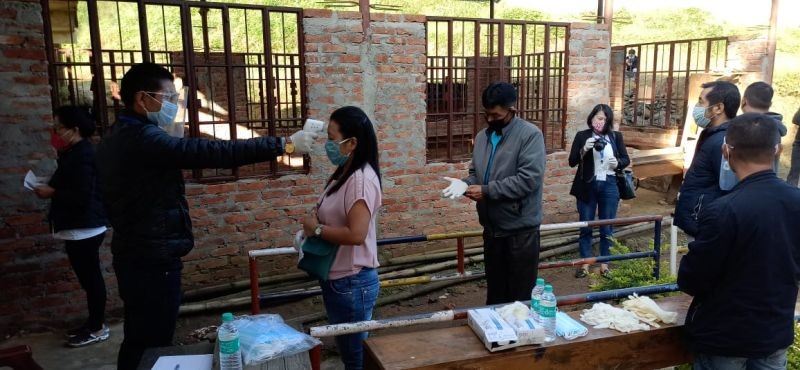 Voters undergoing thermal screening as they queue up outside a polling station during the bye-election at 14-Southern Angami - I Assembly Constituency on November 3. (Morung File Photo)